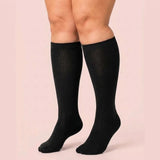 Woman wearing black Velora wide-fit knee-high compression socks