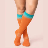 velora patterns wide fit compression socks gradient orange knee high women pose demure crossed